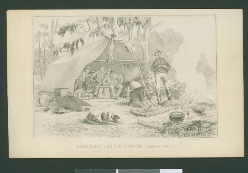 Four men inside a large tent are seated around a chest which is being used as a table. Half a side of a seep hangs from the tent pole above. One man in front of the camp fire rolls up his swag, while another stands with his leg on a log. A dog of indeterminate breed lies to the left. A cradle, shovels and a barrow with a wooden wheel are to the left of the image.